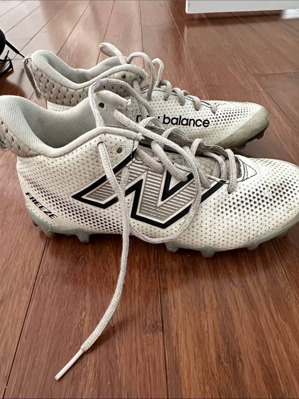 New Balance Kids White Cleats with Black Logo